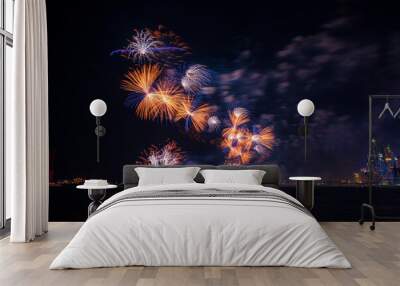 new year celebration with colorful fire crackers and city skyline visible Wall mural