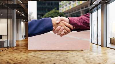 two hands shaking hand on the street Wall mural