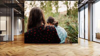 Back view of two young women walking through the field Wall mural