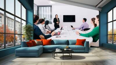 Group of office workers at a meeting around the boss Wall mural