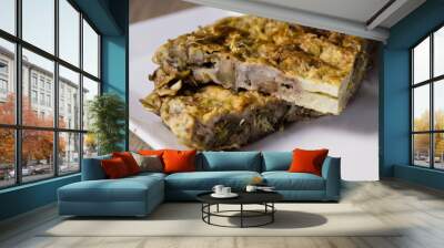 Two servings of artichoke omelet on wooden table Wall mural