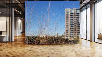 Landscape with building and bright blue sky. Wall mural