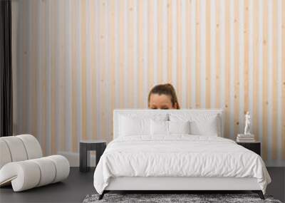 Young woman recording online fitness class content at home Wall mural