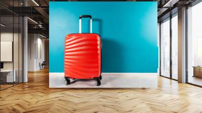 Bright and stylish cabin size suitcase as holiday concept against dark blue background, copy space. Easy travel with little baggage Wall mural