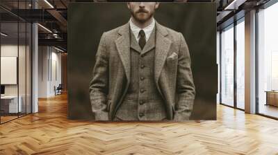 A man dressed in vintage attire, merging traditional style with contemporary assurance, showcases enduring elegance and a unique sense of personality. Wall mural