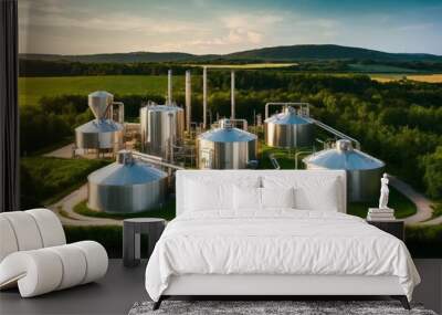 Photo of a brewery style factory with stainless steel tanks in a green nature landscape, friendly atmosphere.Tank farm with rows of oil storage tanks.Tank farm with rows of oil storage tanks Wall mural