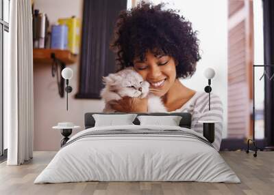 Arent you so cute. Shot of a beautiful young woman enjoying a cuddle with her cat. Wall mural