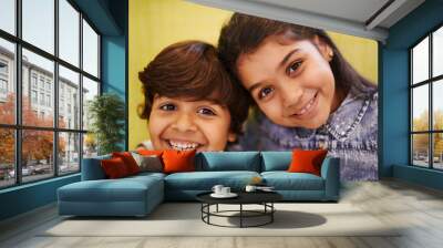 Best friends for a lifetime. Portrait of two siblings standing together indoors. Wall mural