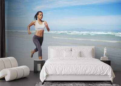 Fitness, space or Indian woman at sea running for exercise, training or outdoor workout at beach. Sports person, runner or healthy female athlete on sand for cardio endurance, wellness or mockup Wall mural