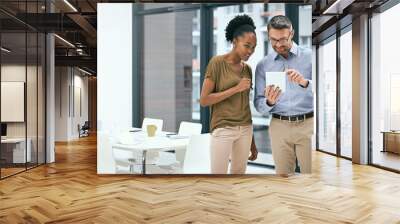 Growing their business through technology. Cropped shot of two colleagues working together on a digital tablet in an office. Wall mural