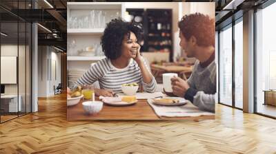 Enjoying a leisurely breakfast together. Shot of a couple eating breakfast together at home. Wall mural