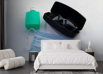 Protective mask and antiseptic on a white background. Wall mural