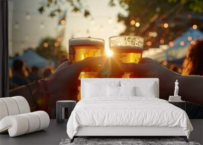 close-up of a toast with two beer glasses at an outdoor location, with the sunset in the background. Wall mural