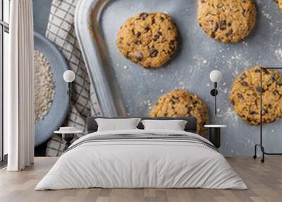 vertical composition of a baking tray with freshly baked chickpea cookies and dark chocolate chips Wall mural