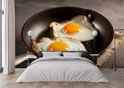 delicious scrambled eggs from two eggs for breakfast in a frying pan, top view. Wall mural