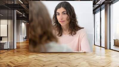 Conversation of two young women in a consultation Wall mural