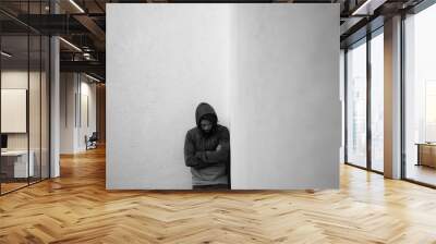 Man standing in a corner alone Wall mural