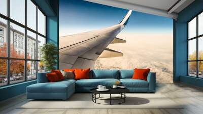 window view of aircraft wing flying over clouds in blue sky (boeing 737) Wall mural