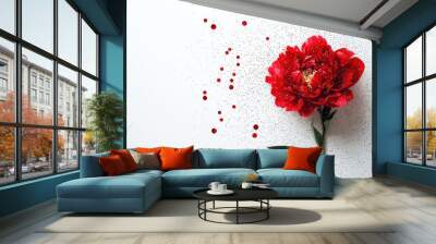 A stunning red flower highlighted with a touch of glitter, positioned on a crisp white background showcasing the elegance and simplicity of natural beauty. Wall mural