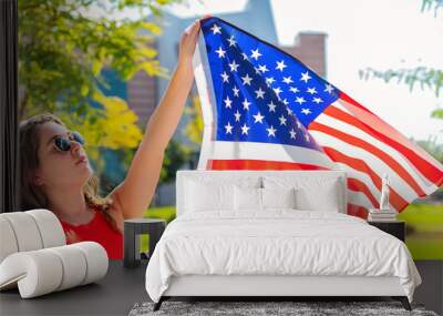 American flag, young beautiful woman holding USA flag. Wall mural