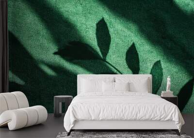 abstract botanical pattern sunlight shadow silhouette of leaves on linen sage green fabric aesthetic background for sustainable eco business brand Wall mural