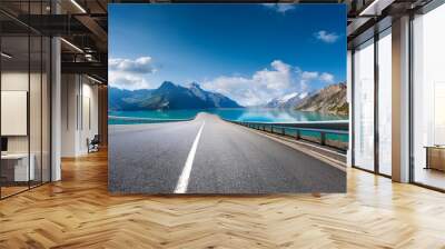 asphalt highway road and blue lake with mountain nature landscape under blue sky Wall mural