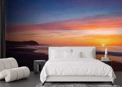 early morning seascape over beach with silhouetted coastline and colourful dawn sky Wall mural