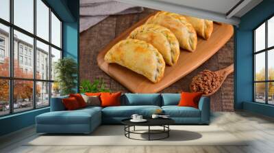 Meat roasted empanas on wooden background Wall mural