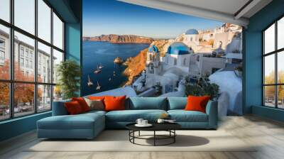 Traditional white houses with blue dome churches on the cliff, Santorini, Greece. Morning light Wall mural