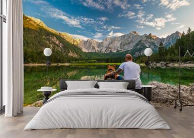 Tattoed Man with Dog Looking at Beautiful Lake and Mountains. Outdoor Active  Lifestyle Wall mural