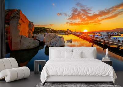 A sunset over lake with a port in the background Wall mural