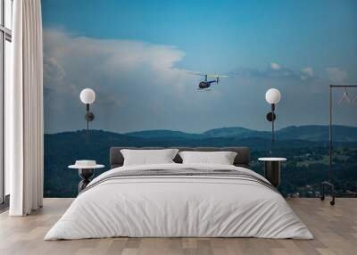 Robinson 44 Raven II helicopter at flight over Karkonosze mountains in Poland Wall mural