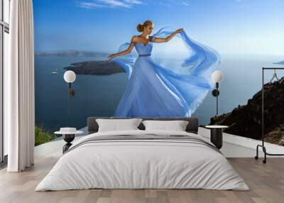 Elegant luxury evening fashion. Glamour, stylish elegant woman in long gown dress is posing outdoor in luxury resort in Santorini. Female model in amazing long dress. Vogue. Couture. Wall mural