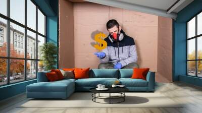 man in a protective mask sits at a cardboard box, extends his hand, begs for a dollar Wall mural