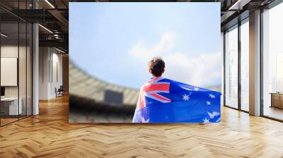 An athlete with the Australian flag draped over their shoulders, representing Australia in the stadium during a major international sporting event Wall mural