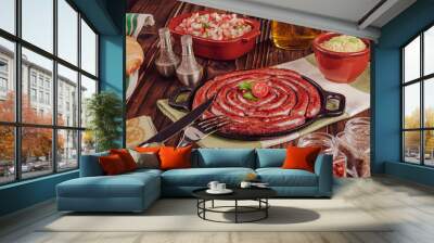 Grilled brazilian sausage on iron plate with bread, salad, farofa and spices - Linguiça Wall mural