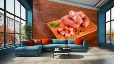 Raw brazilian bacon sausages on the wooden board with fresh cubes of bacon and spices - Linguiça de bacon isolated Wall mural