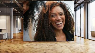 A happy black woman laughing and smiling a casual hispanic 40s lady real life laugh and smile Wall mural