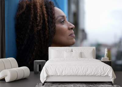 a hopeful black african woman smiling looking at sky having faith Wall mural