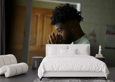 A religious black man praying to God with seeking divine help Wall mural