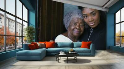 A teen granddaughter taking care of grandmother giving help and support Wall mural