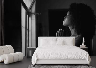 A woman praying at home by window having HOPE and FAITH in monochrome Wall mural