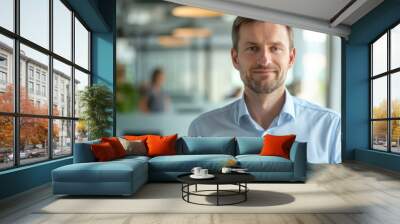 adult confident man in a blue shirt on a background of an office room
 Wall mural