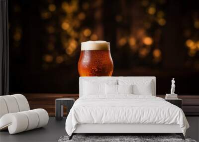  a glass of homebrew beer with a beautiful head, resting on a rustic wooden table, dark background Wall mural