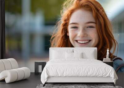 beautiful redhead student smiling at the camera Wall mural