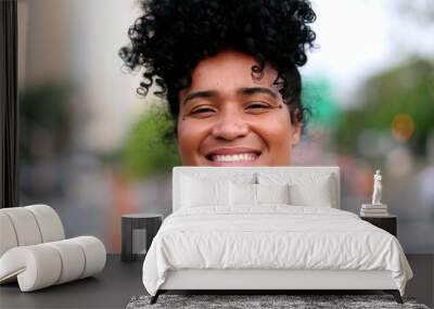 Brazilian woman smiling at camera in urban city in background Wall mural