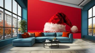 Christmas hat on red background, copy space Wall mural