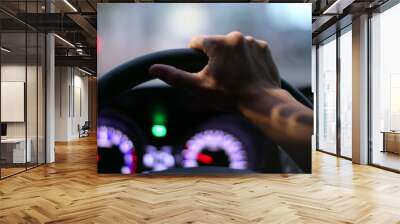 Closeup driver POV holding steering wheel driving at night Wall mural