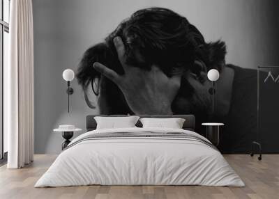 Dramatic depressed young man suffering from emotional pain. Somber closeup face of a male person in 30s feeling sadness and lost in monochromatic black and white Wall mural