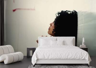 Faithful hispanic young woman praying to God during difficult times. South American Brazilian person in prayer sitting on floor in crisis Wall mural